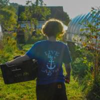 The SAP floral intern heads back to the garage with a fresh harvest of flowers.